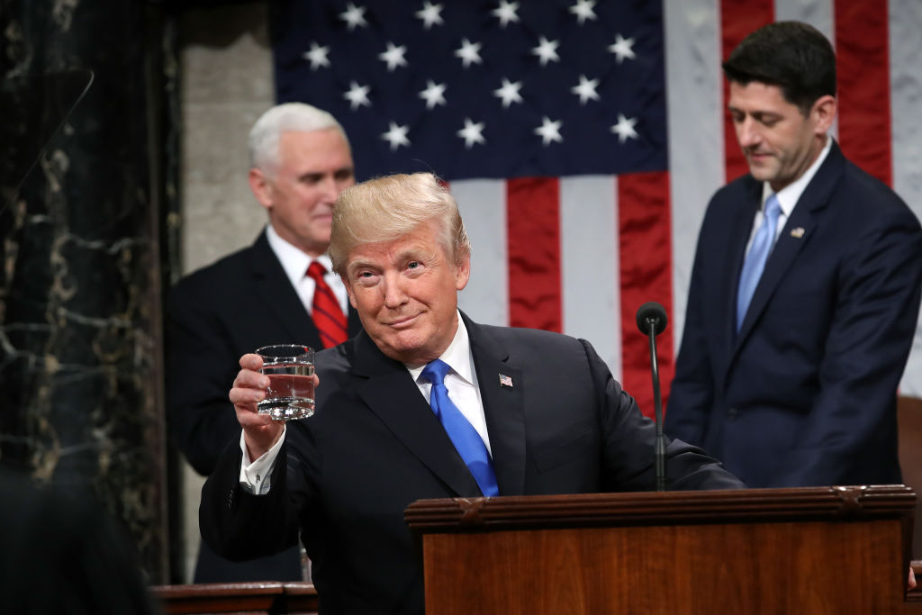 U.S. President Donald Trump, center, gestures before delivering a State of the Union address to a joint session of Congress at the U.S. Capitol in Washington, D.C., U.S., on Tuesday, Jan. 30, 2018. rump sought to connect his presidency to the nation's prosperity in his first State of the Union address, arguing that the U.S. has arrived at a "new American moment" of wealth and opportunity. Photographer: Win McNamee/Pool via Bloomberg