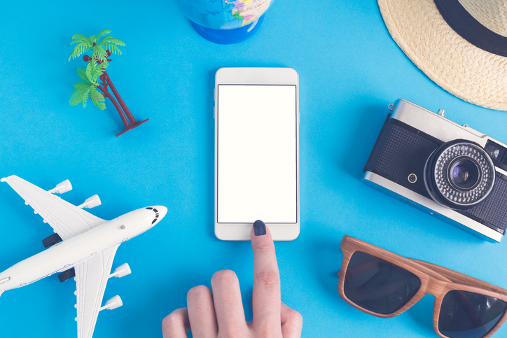 Smartphone surrounded by travel objects