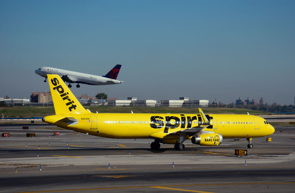NEW YORK, NY - OCTOBER 4, 2017: A Spirit Airlines passenger jet (Airbus A321) lands at LaGuardia Airport in New York, New York.