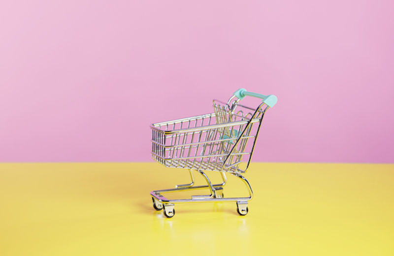 toy shopping trolley with pink  and yellow background