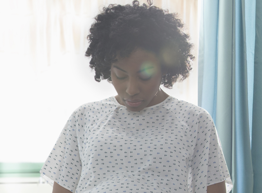 Black woman in hospital gown