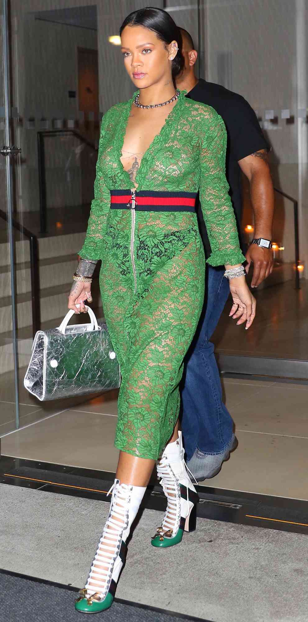 Rihanna enjoys a casual night out at The Edition Hotel in New York City. The Barbadian pop star wore a green Gucci cotton-blend lace dress with a ribbed-knit waistband, ruffled trims and polished two-way zip. She paired her dress with Gucci Finnlay leathe