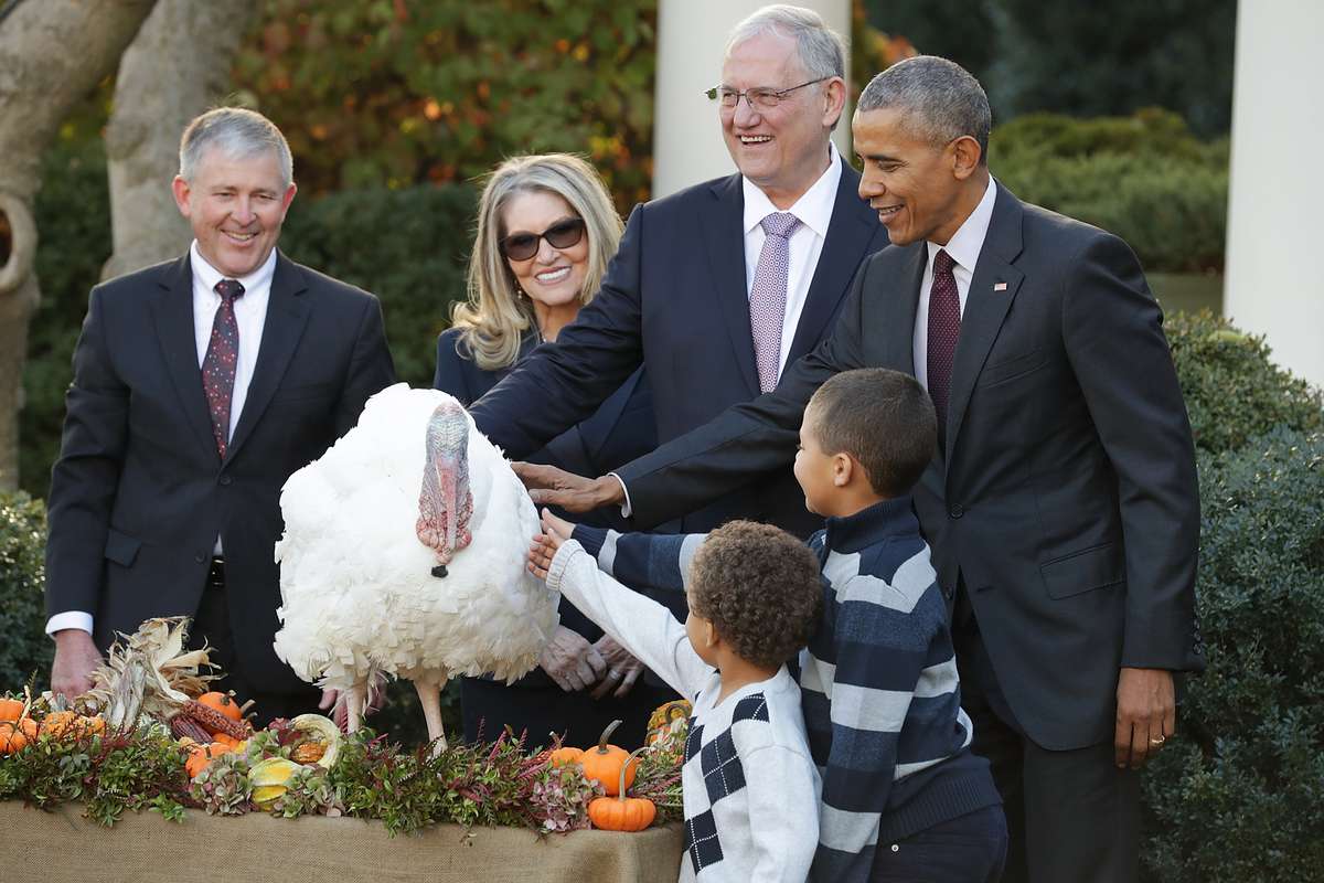 U.S. President Barack Obama (R) pardons the National Thanksgiving Turkey, 'Tot,' with his nephews Aaron and Austin Robinson and National Turkey Federation Chairman John Reicks during a ceremony in the Rose Garden at the White House November 23, 2016 in Wa