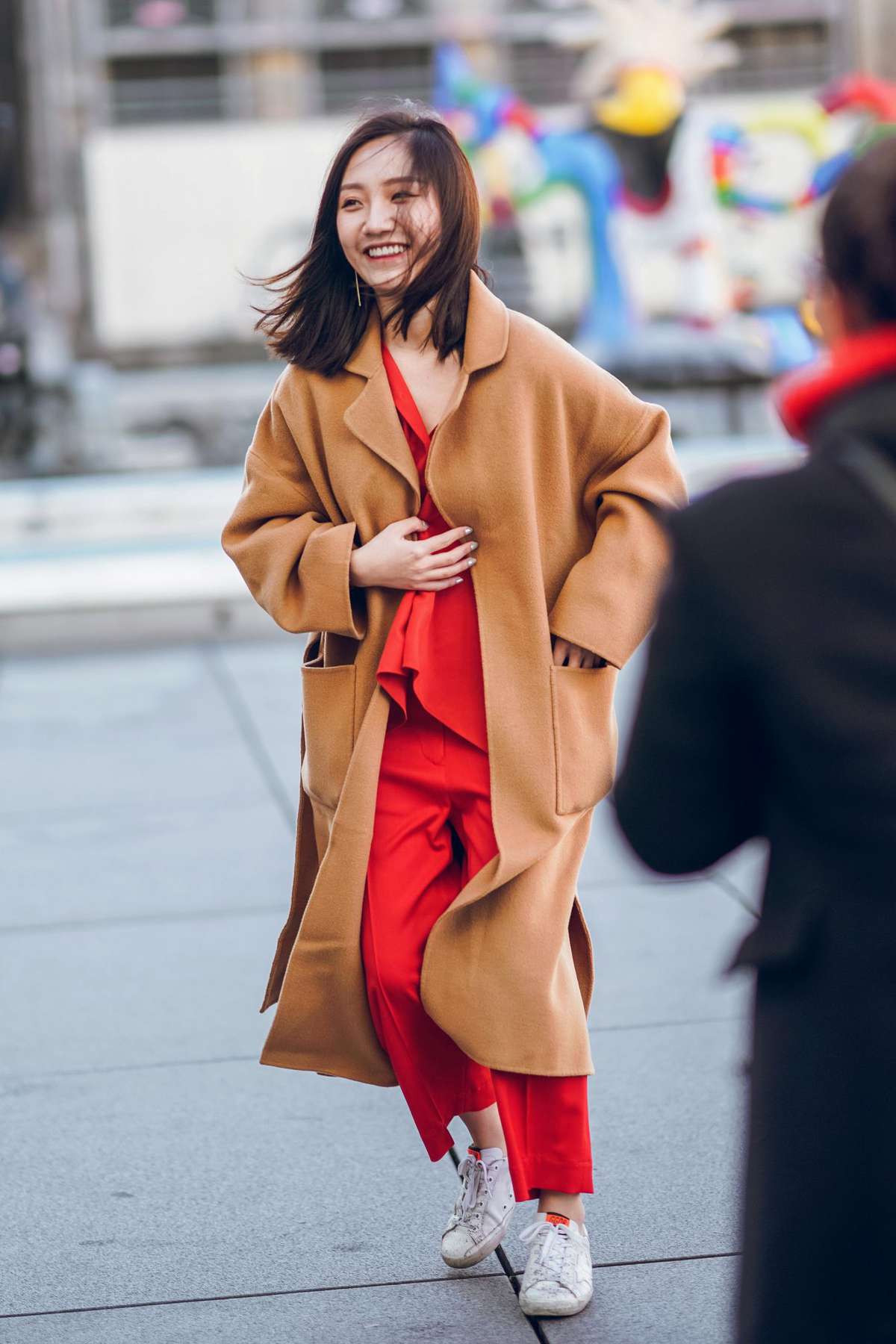 Woman in Camel Coat and Sneakers