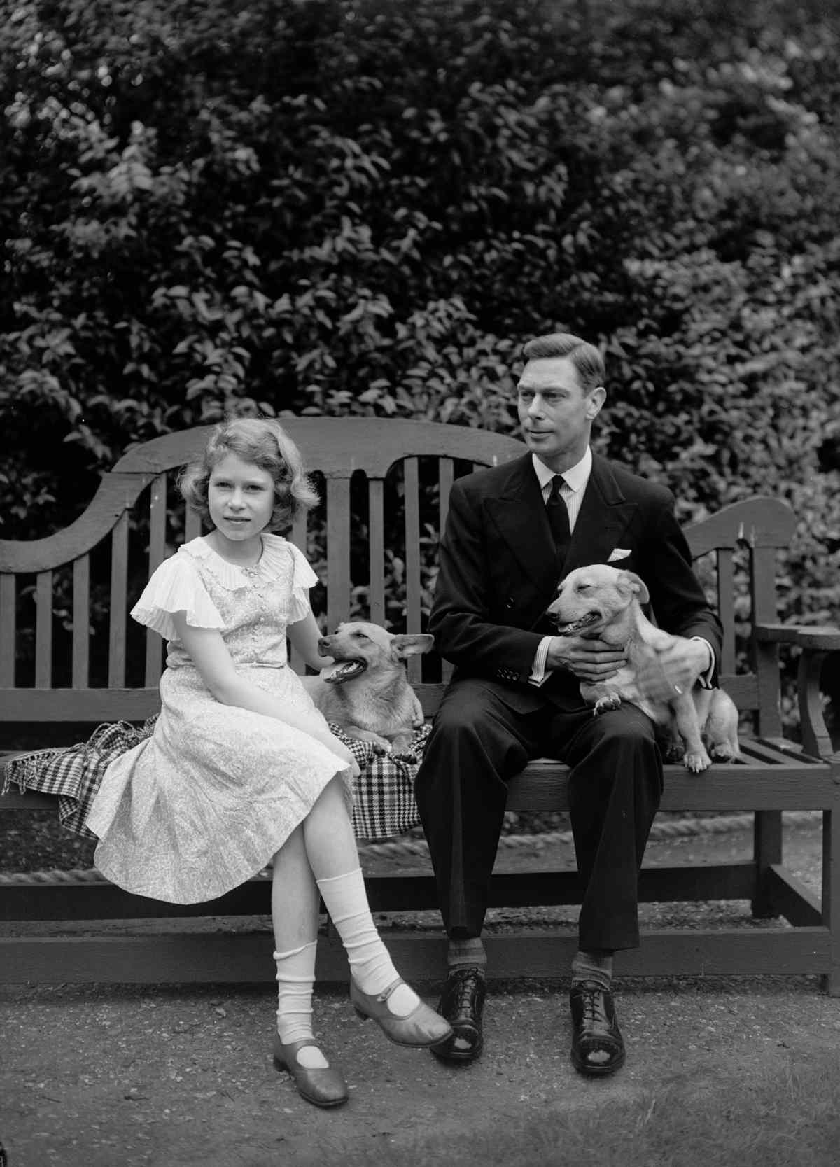 Queen Elizabeth and her father, the Duke of York, hang out at home with their corgis