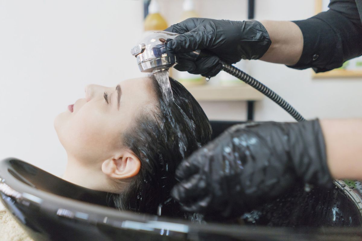 salon hair wash on woman with dark hair