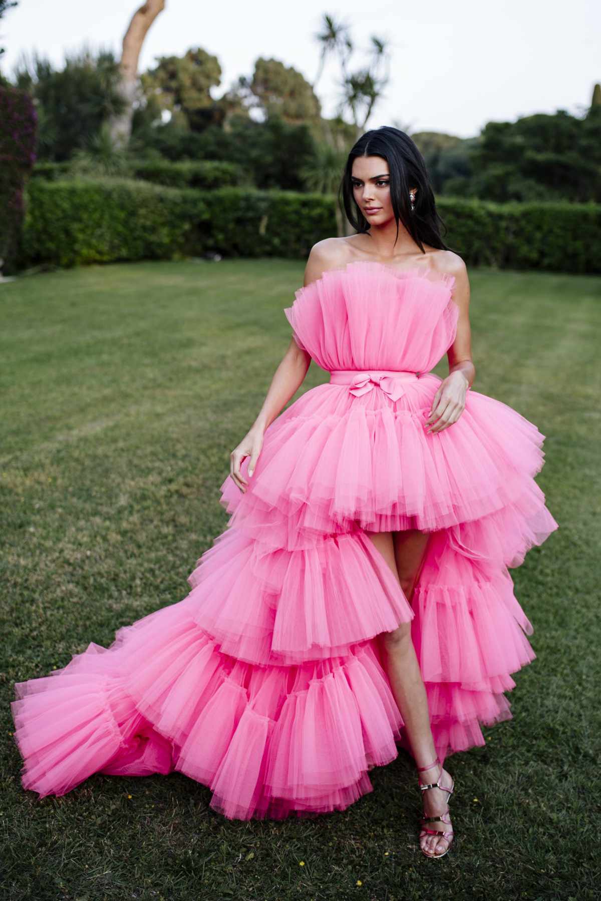 <p>A vision in pink! Kendall Jenner attended the 2019 amfAR Cannes Gala in this dreamy pink Giambattista Valli. The strapless gown draped layers and layers of tulle and cinched at the waist with an adorable bow --  a dress fit for a princess. Jenner exuded regality while roaming Hotel du Cap-Eden-Roc. Her dark brown hair delightfully contrasted the bright shade of the dress, while her rose mirrored sandals accented it. </p>
                            
