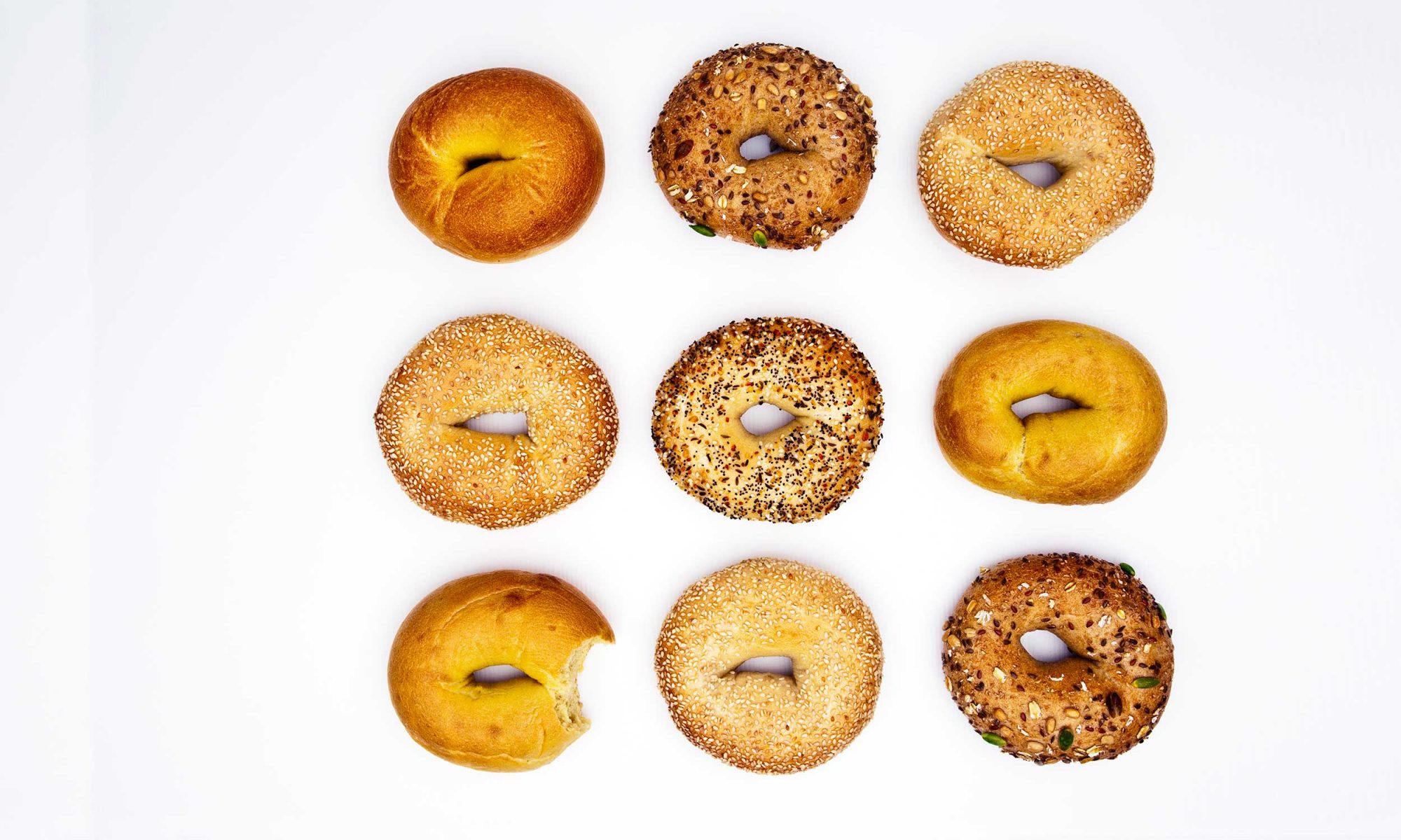 Assorted bagels on white background