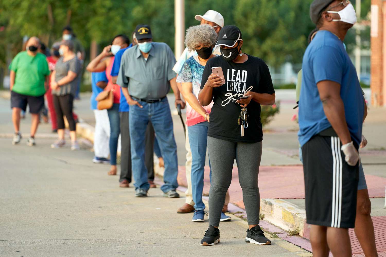 Voters stand in line before the polling center