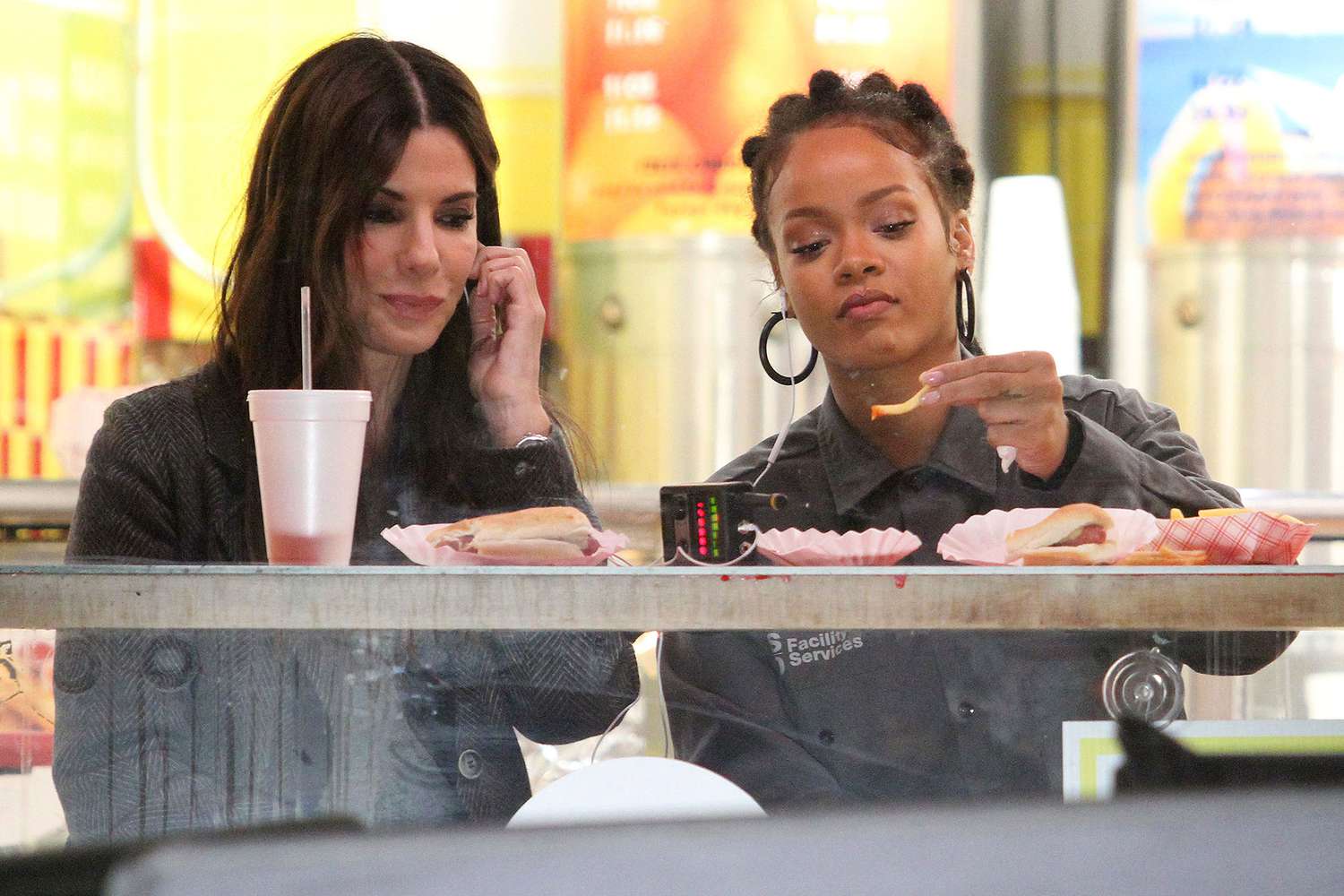 Sandra Bullock and Rihanna eat hot dogs and french fries on the set of OCEANS 8