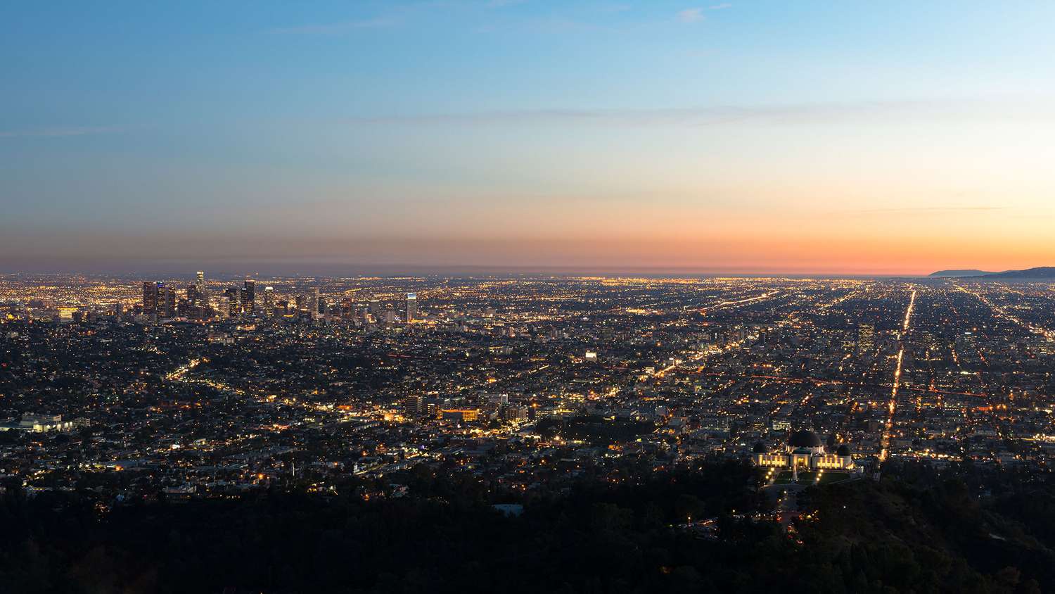 USA, California, Los Angeles, Illuminated cityscape at sunrise