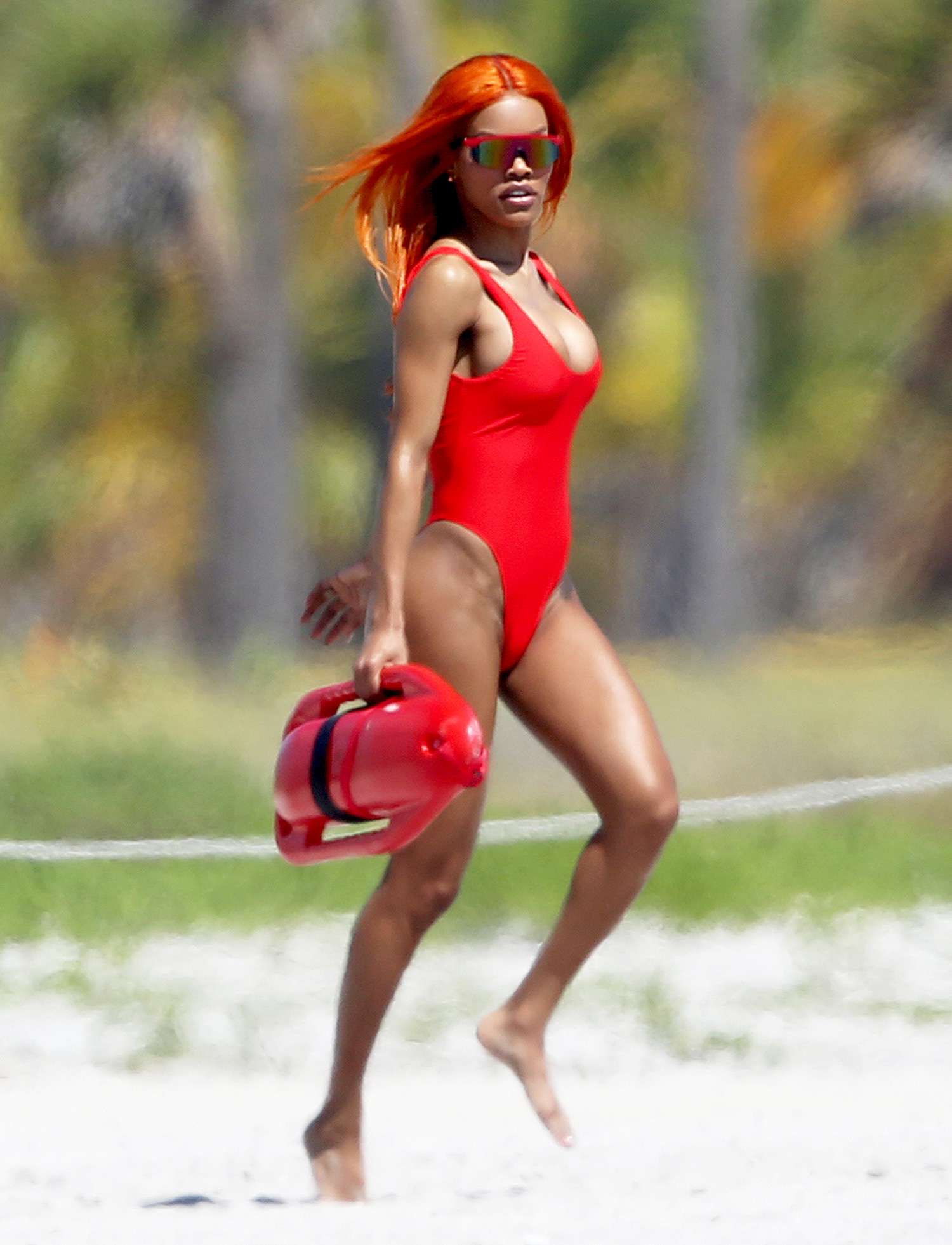 Singer and Model Teyana Taylor Wears A Cheeky Red Swimsuit During A Photoshoot On The Beach In Miami