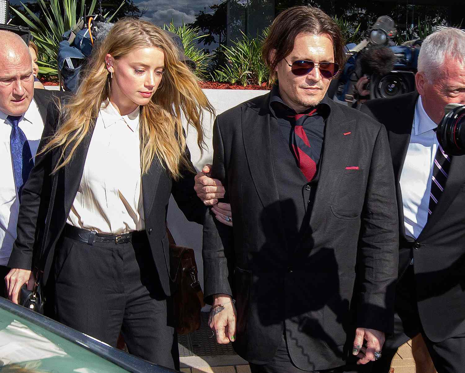 Amber Heard and Johnny Depp leave Southport Magistrates Court after signing a deal for dog smuggling charges laid against them.