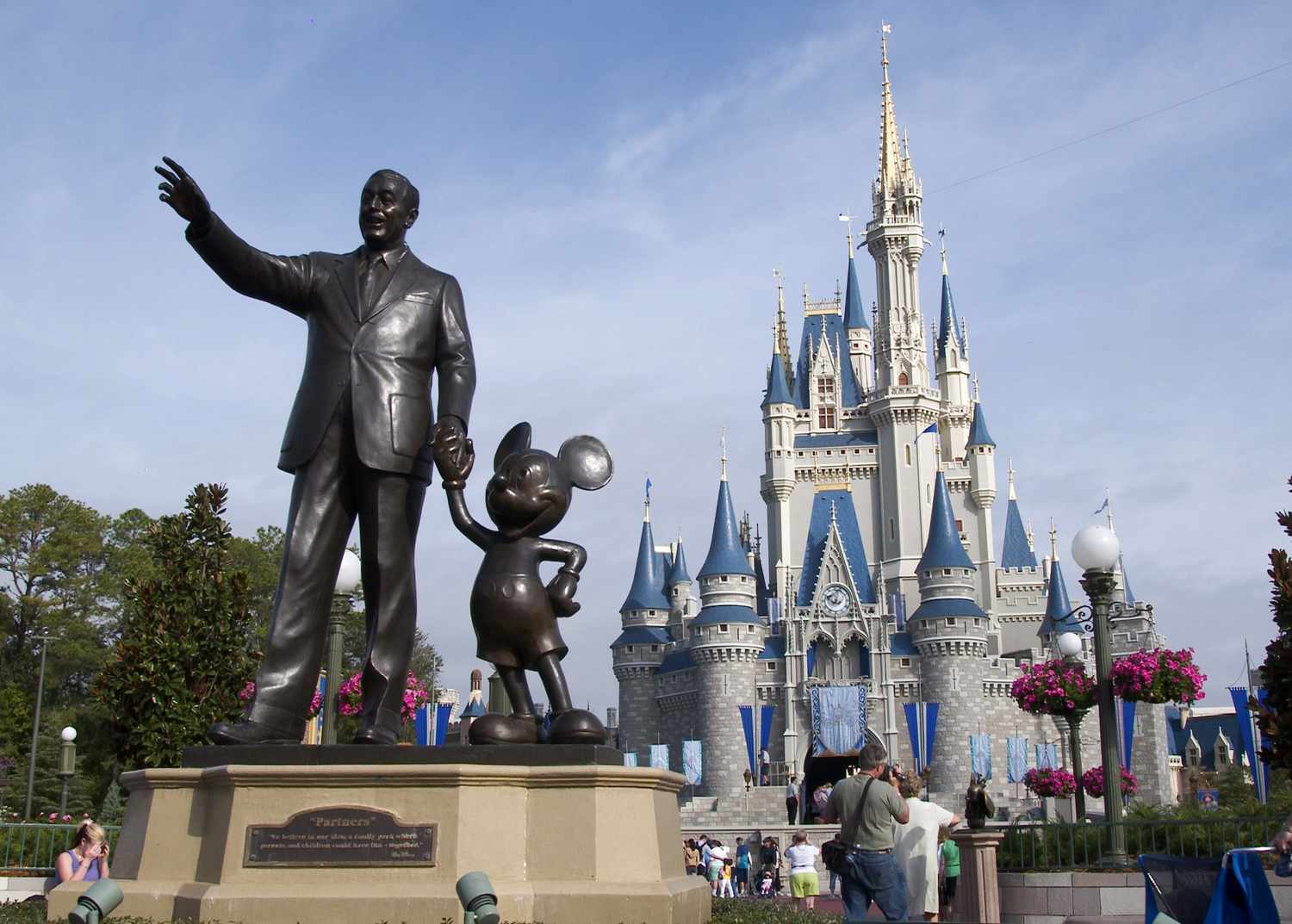 A statue of Walt Disney and Mickey Mouse stands in front of