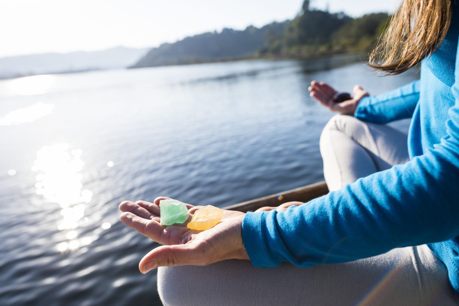 Woman Meditating On A Calm Lake