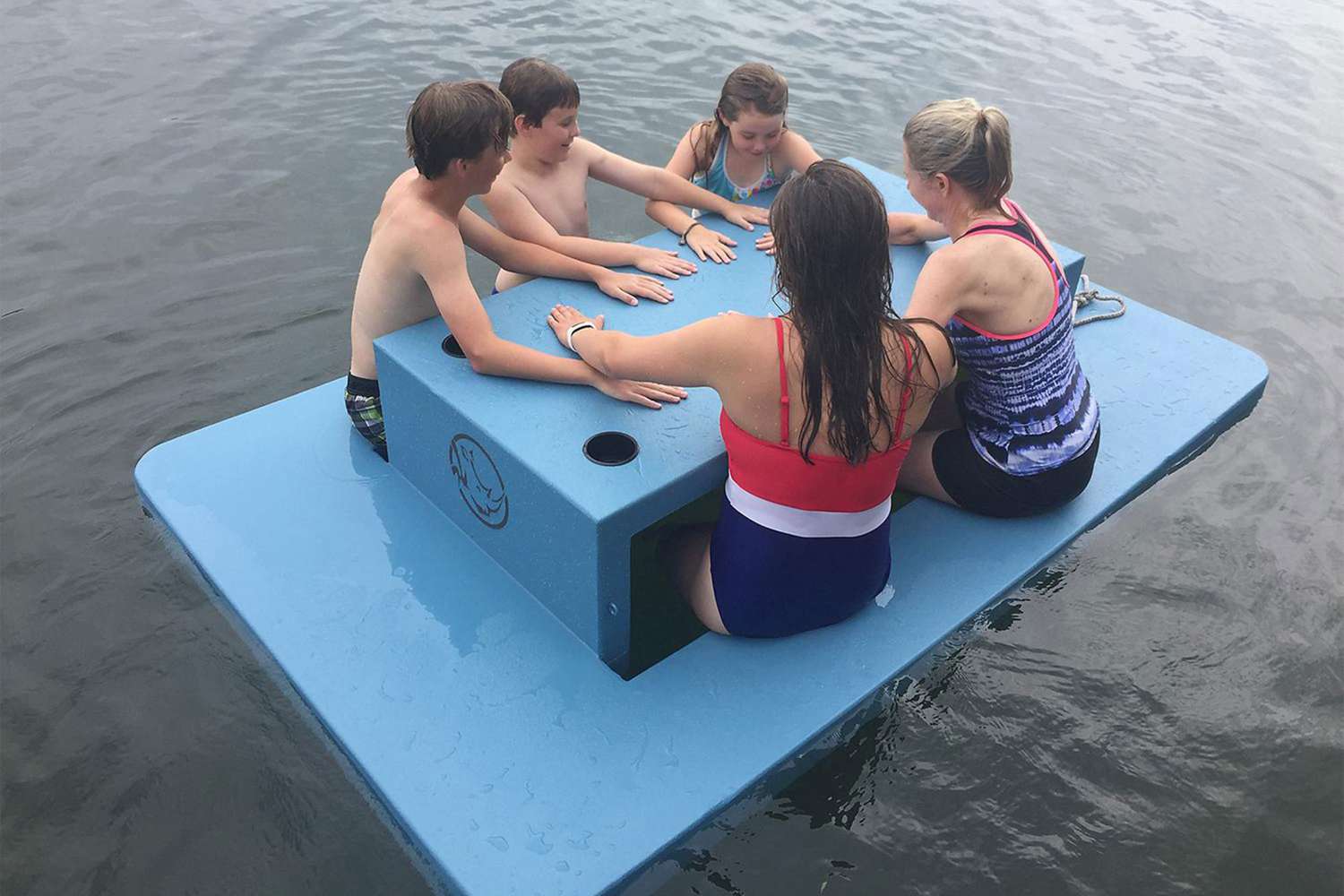 kids using floating picnic table in water