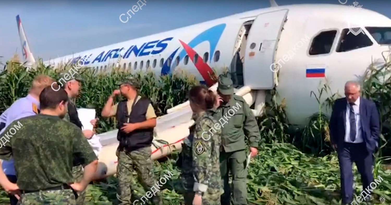 A handout still image taken from a video footage released by the Russian Investigative Committee shows investigators near the Ural Airlines A-321 passenger plane on the site of its emergency landing in a field outside Zhukovsky airport in Ramensky district of Moscow region, 15 August 2019