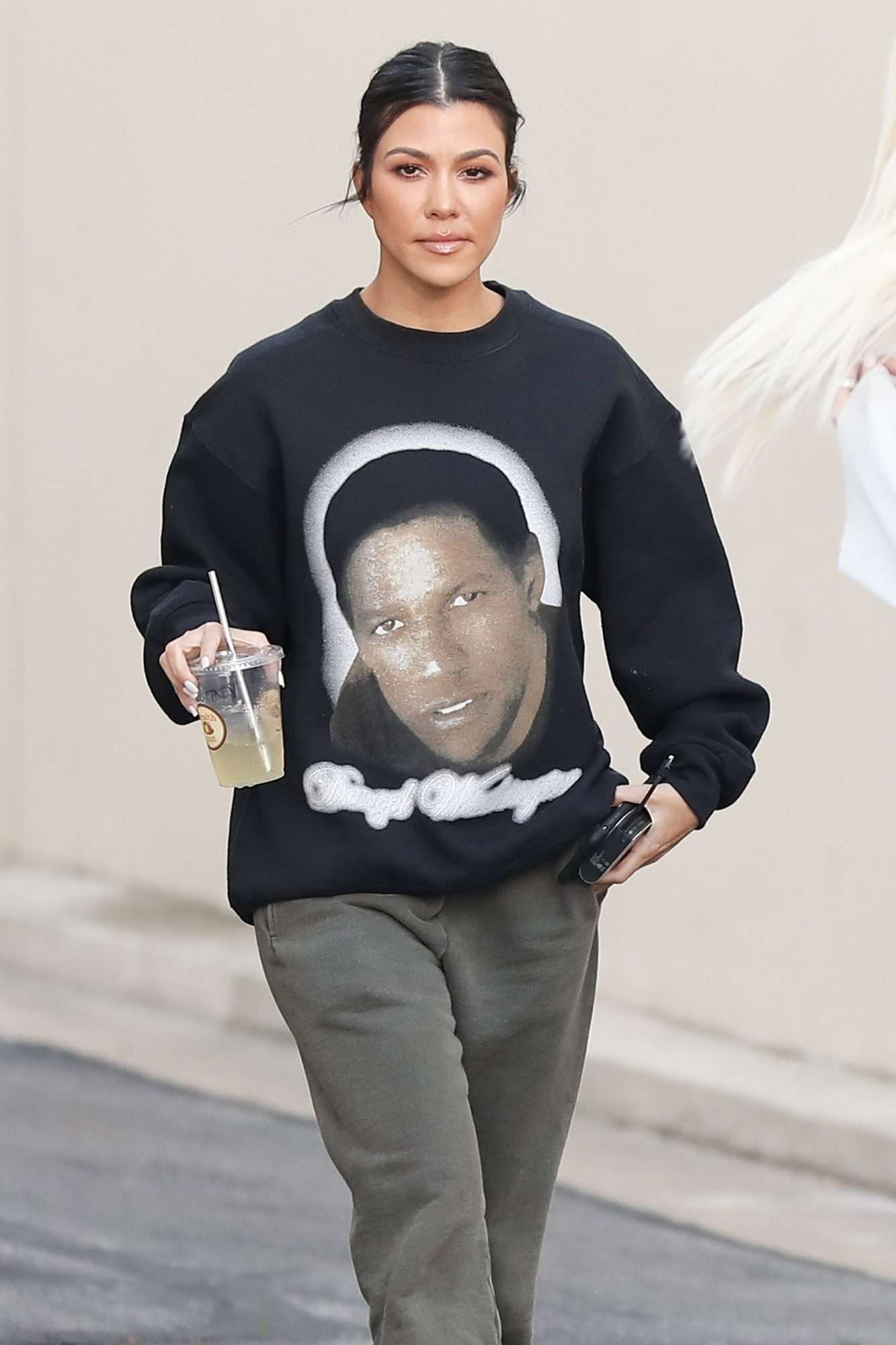 Kourtney Kardashian shows off her Denzel Washington sweater at the studio with Khloe