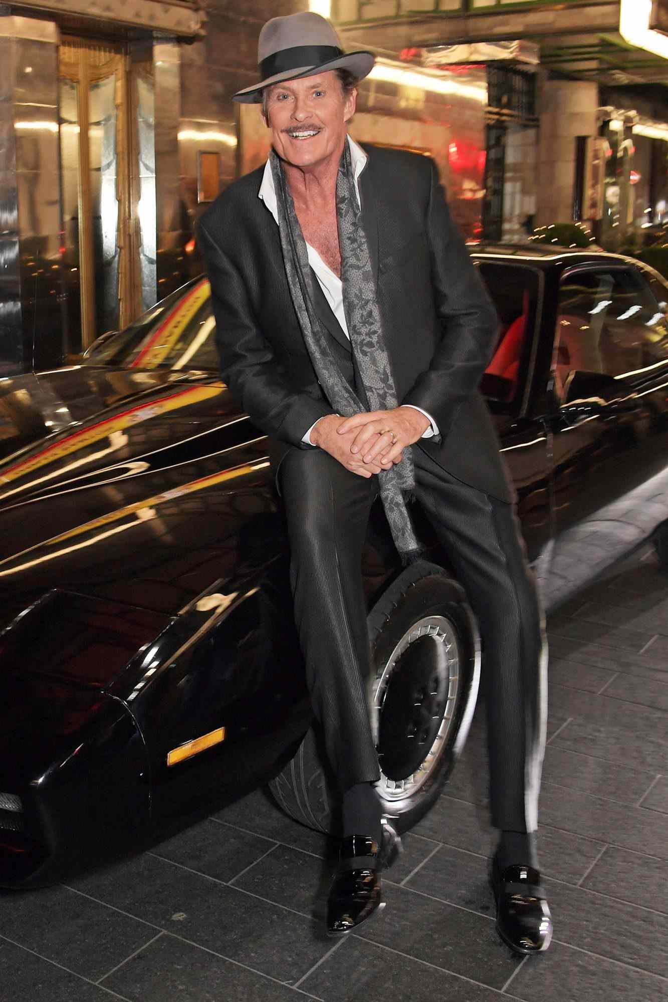 David Hasselhoff poses with KITT from Knight Rider at the gala party to celebrate David Hasselhoff joining the cast of the West End production of "9 To 5: The Musical" at The Savoy Theatre on December 11, 2019 in London, England