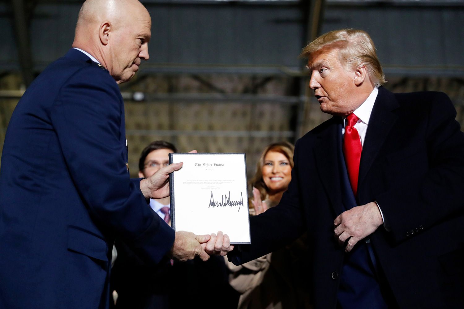 President Donald Trump shakes hands with Gen. Jay Raymond, after signing the letter of his appointment as the chief of space operations for U.S. Space Command during a signing ceremony for the National Defense Authorization Act for Fiscal Year 2020 at Andrews Air Force Base, Md Trump, Andrews Air Force Base, USA - 20 Dec 2019