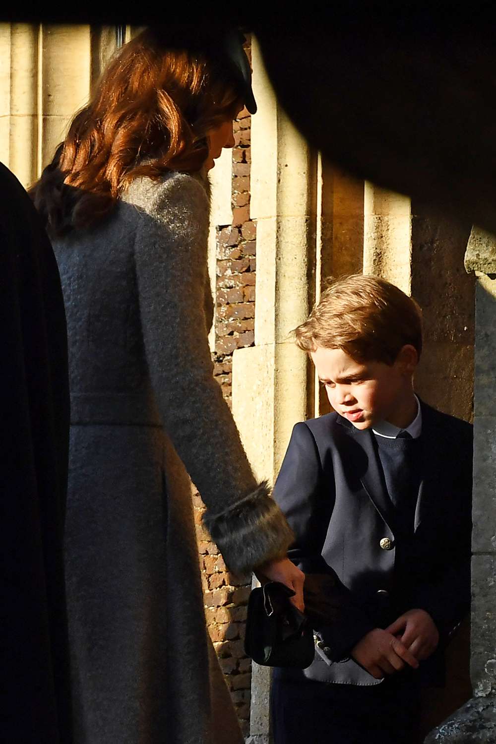 Britain's Prince George of Cambridge (R) and his mother Britain's Catherine, Duchess of Cambridge arrive for the Royal Family's traditional Christmas Day service at St Mary Magdalene Church in Sandri ngham, Norfolk, eastern England, on December 25, 2019. (Photo by Ben STANSALL / AFP) (Photo by BEN STANSALL/AFP via Getty Images)