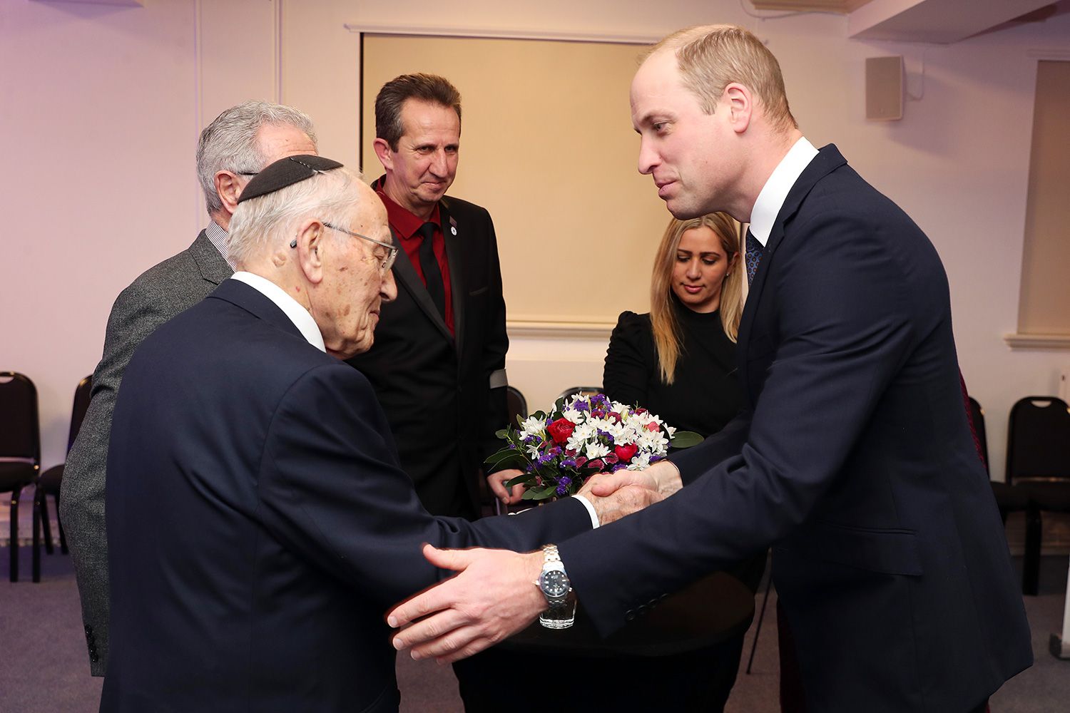 Prince William, Duke of Cambridge shakes hands with Manfred Goldberg at the UK Holocaust Memorial Day Commemorative Ceremony in Westminster on January 27, 2020 in London