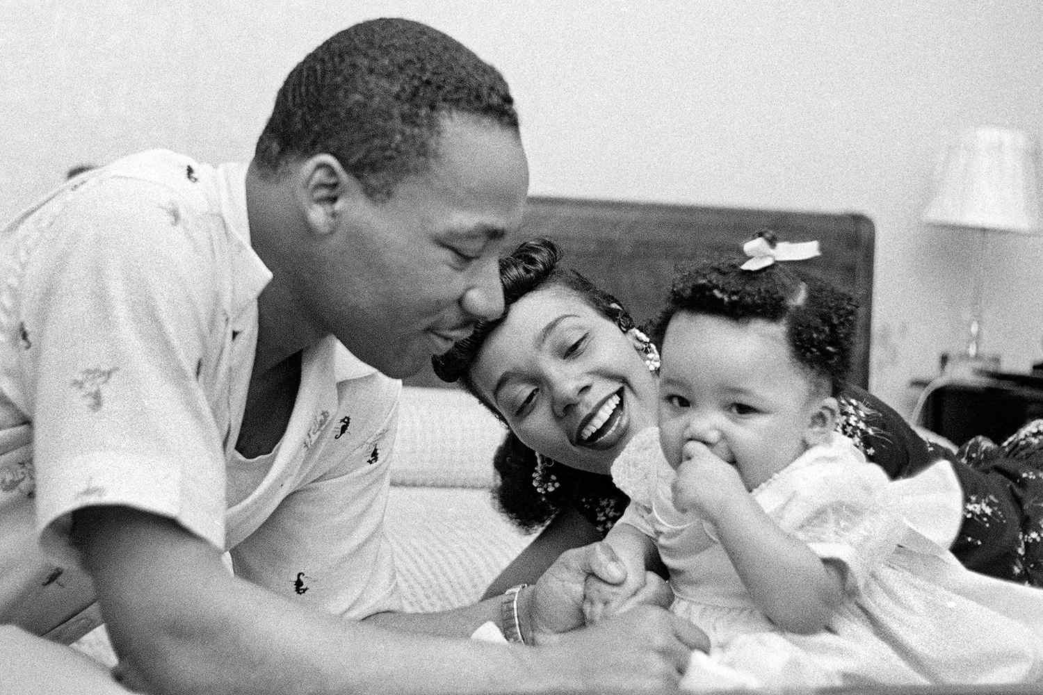 Civil rights leader Reverend Martin Luther King, Jr. relaxes at home with his wife Coretta and first child Yolanda in May 1956 in Montgomery, Alabama