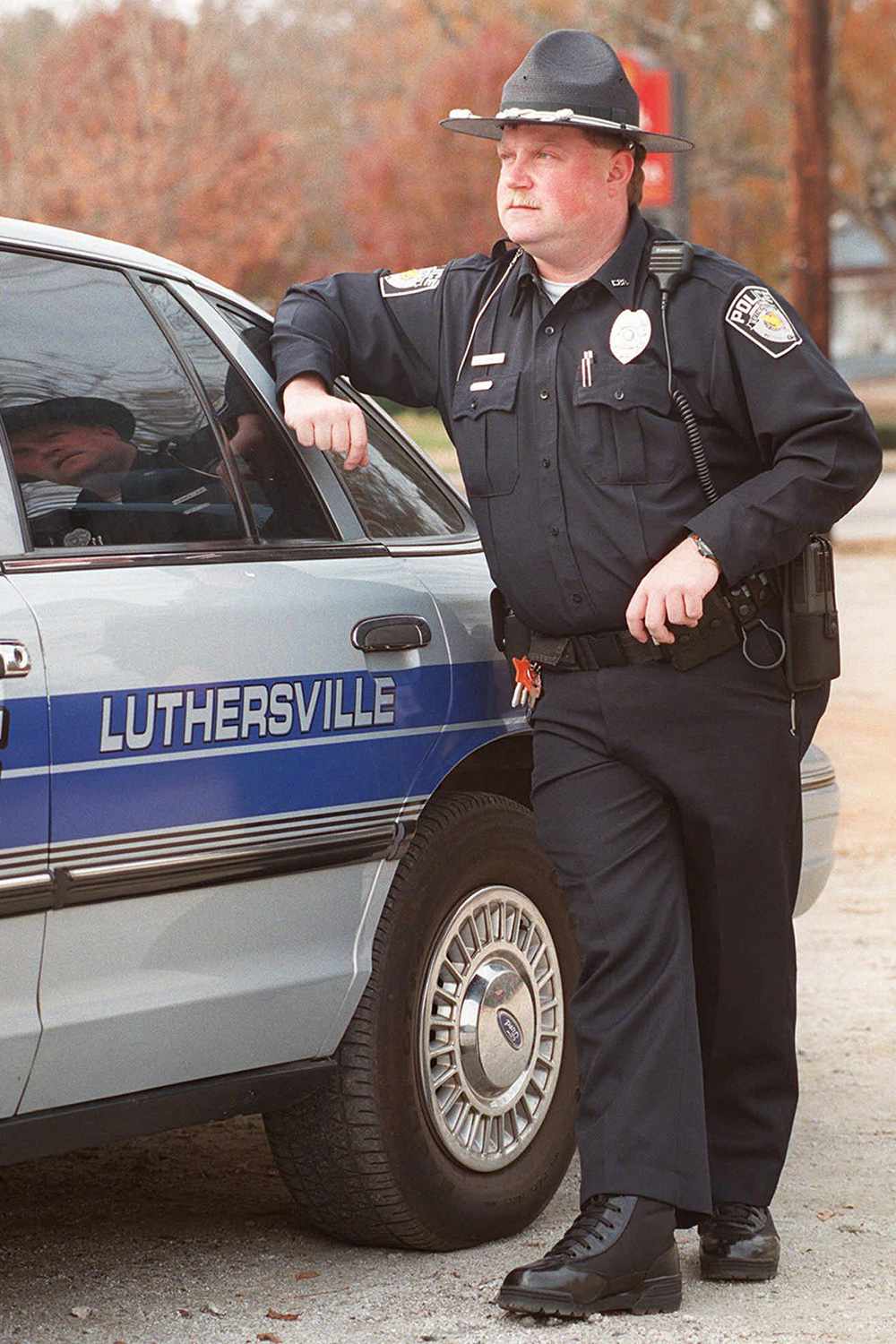 Richard Jewell, stands by one of the department's patrol cruisers in the small Georgia town of Luthersville, Ga., on . Jewell, a former suspect in the Olympic Park bombing, joined the five-man force on Tuesday