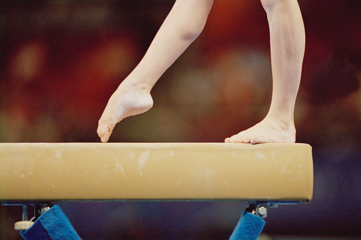 Gymnast on balance beam, low section, close-up