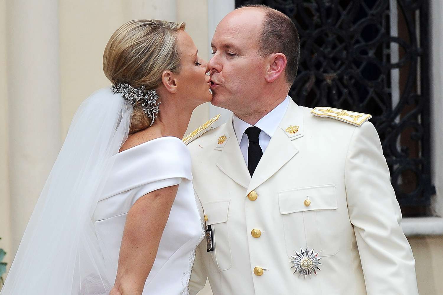 Princess Charlene of Monaco and Prince Albert II of Monaco kiss as they leave Sainte Devote church after the religious ceremony of their Royal Wedding at the Prince's Palace on July 2, 2011 in Monaco