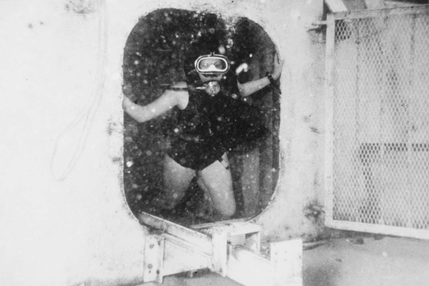 (Original Caption) Stepping Out. Great Lameshur Bay, St. John, Virgin Islands: Dr. Sylvia A. Farle, captain of the five-woman team of scientist-aquanauts conducting two weeks of tests 50 feet down in Caribbean waters here, moves out of hatch of Tektite 2 twin-cylinder habitat to start one of many experiments. The women were in their fourth day of underwater living.