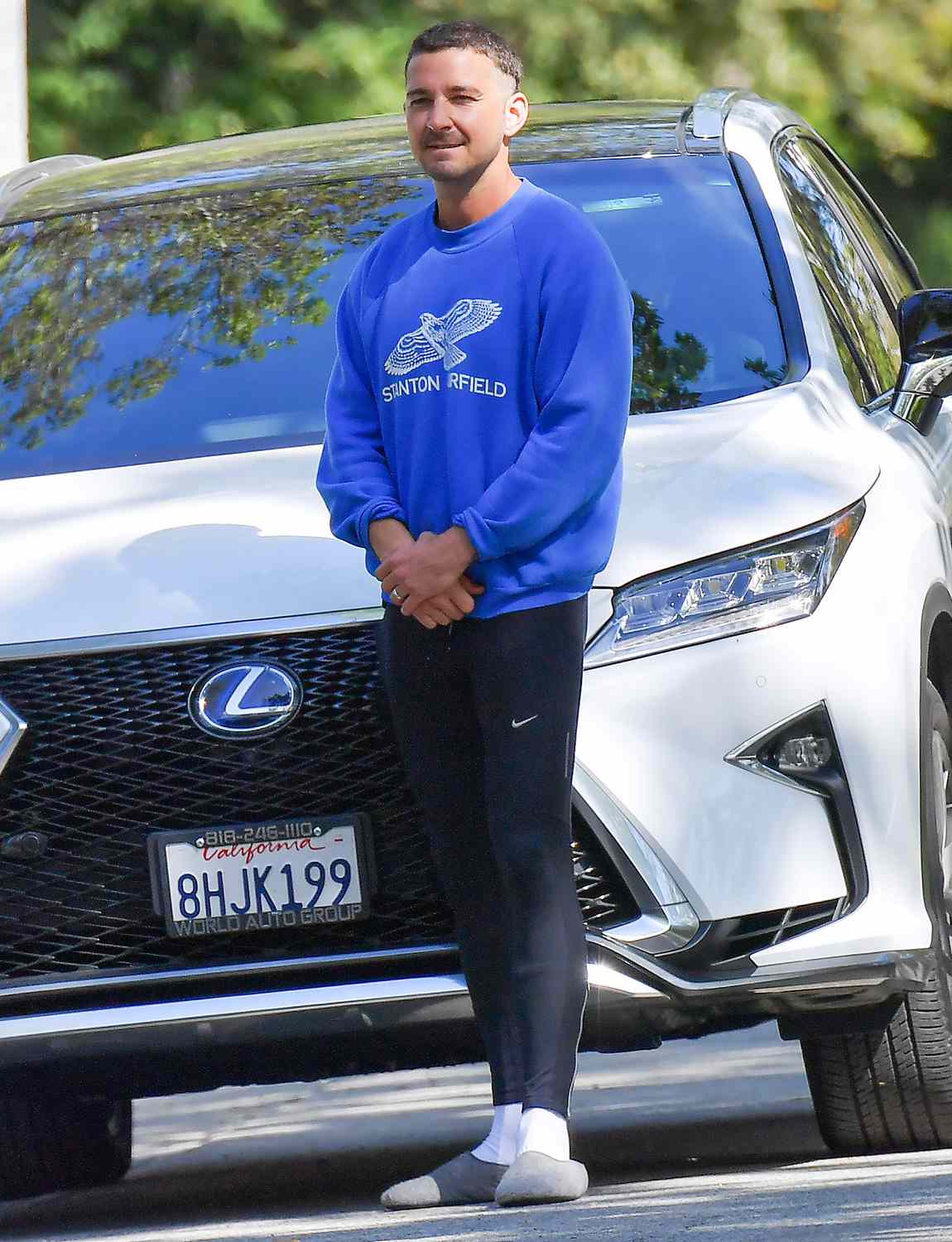 Shia Labeouf blocks in a paparazzi while out for a walk in his Pasadena neighborhood