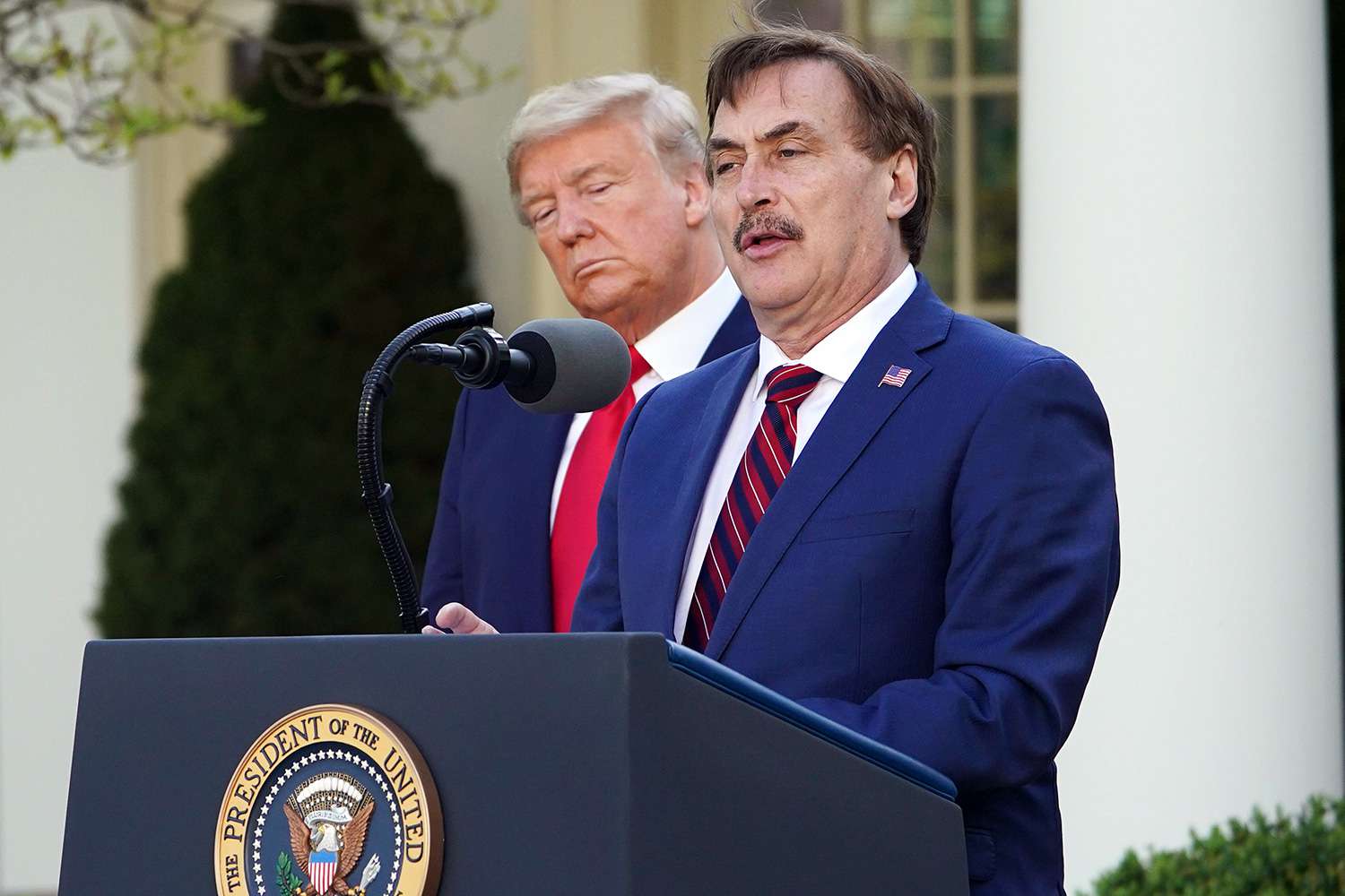 US President Donald Trump listens as Michael J. Lindell, CEO of MyPillow Inc., speaks during the daily briefing on the novel coronavirus