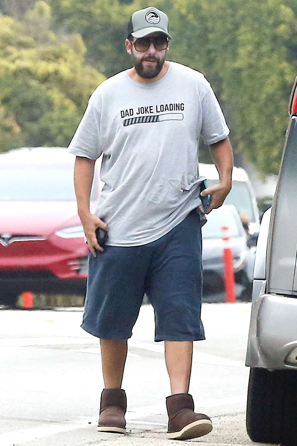 Adam Sandler has food delivered to the back of their car in Malibu, California