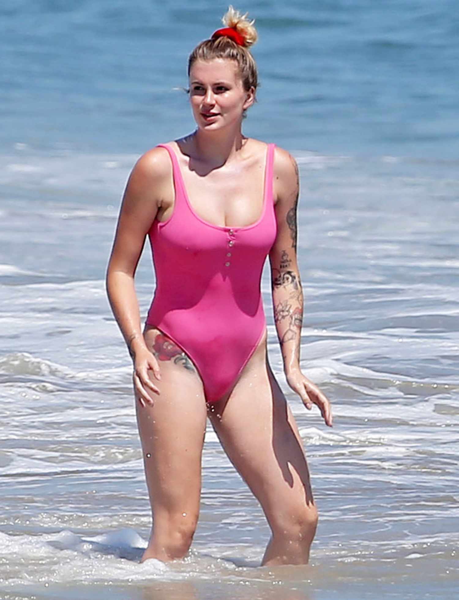 Ireland Baldwin wears a pink one-piece bathing suit while at the beach in Malibu