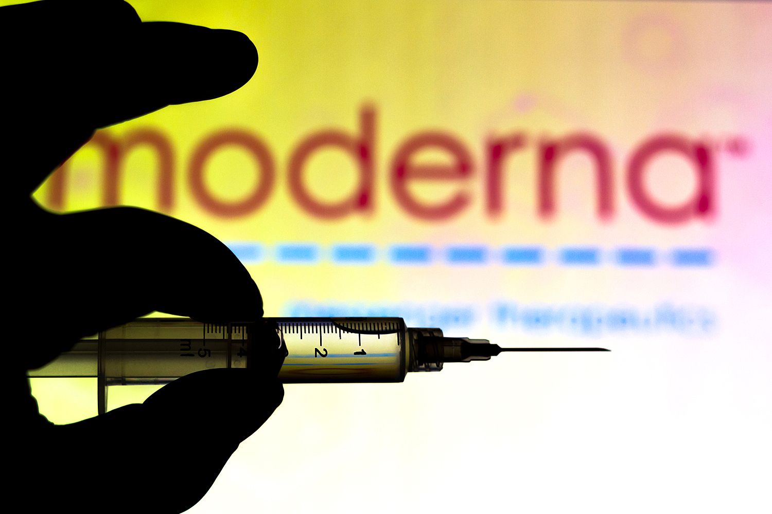 Medical syringe is seen with Moderna Therapeutics company logo