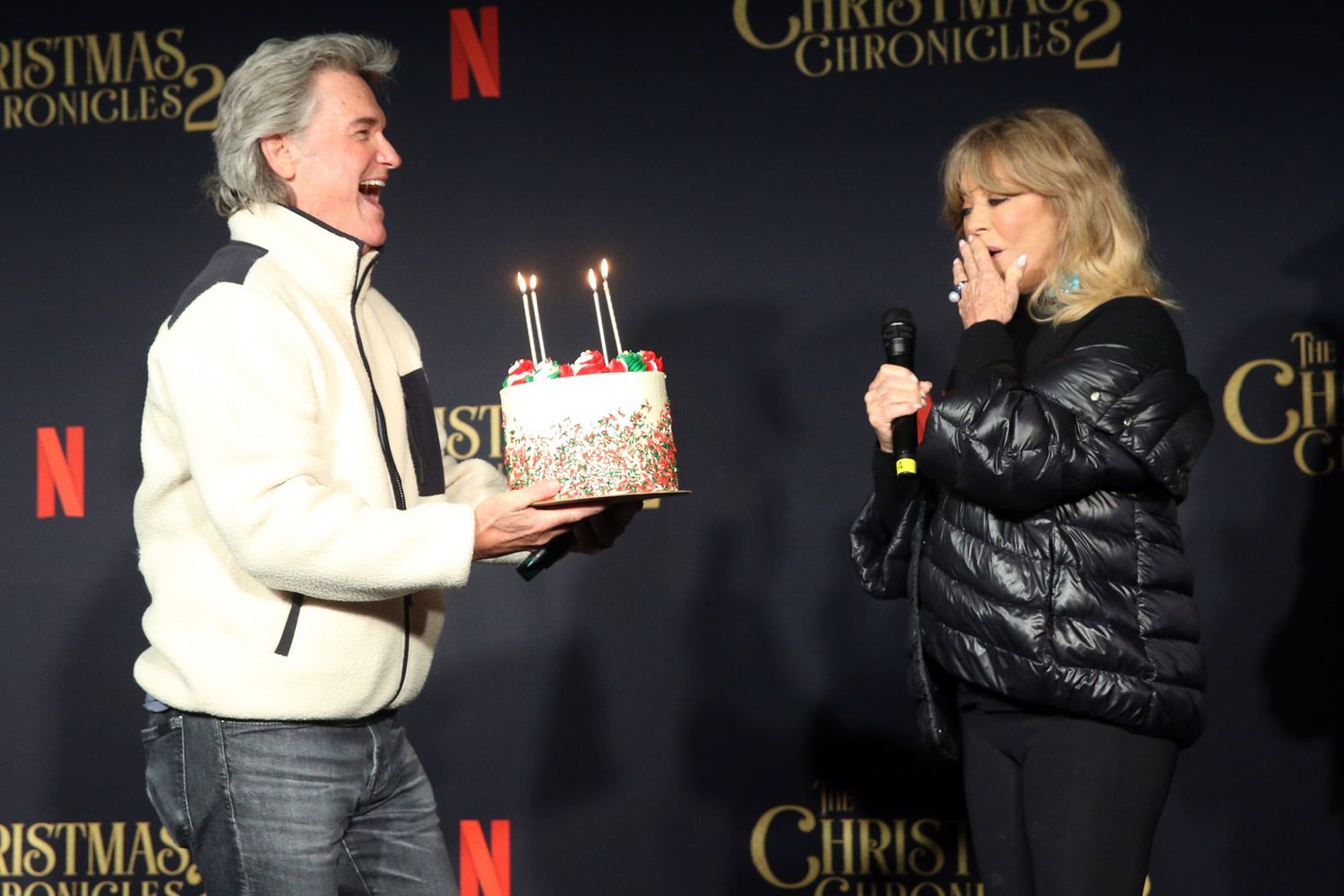 Kurt Russell (L) presents Goldie Hawn with a cake for her milestone birthday at Netflix's "The Christmas Chronicles: Part Two" Drive-In Event at The Grove