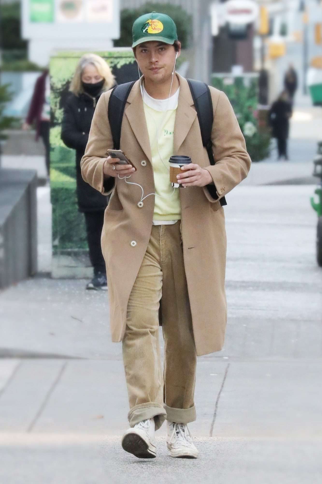 Cole Sprouse facetimes a friend while out for a walk