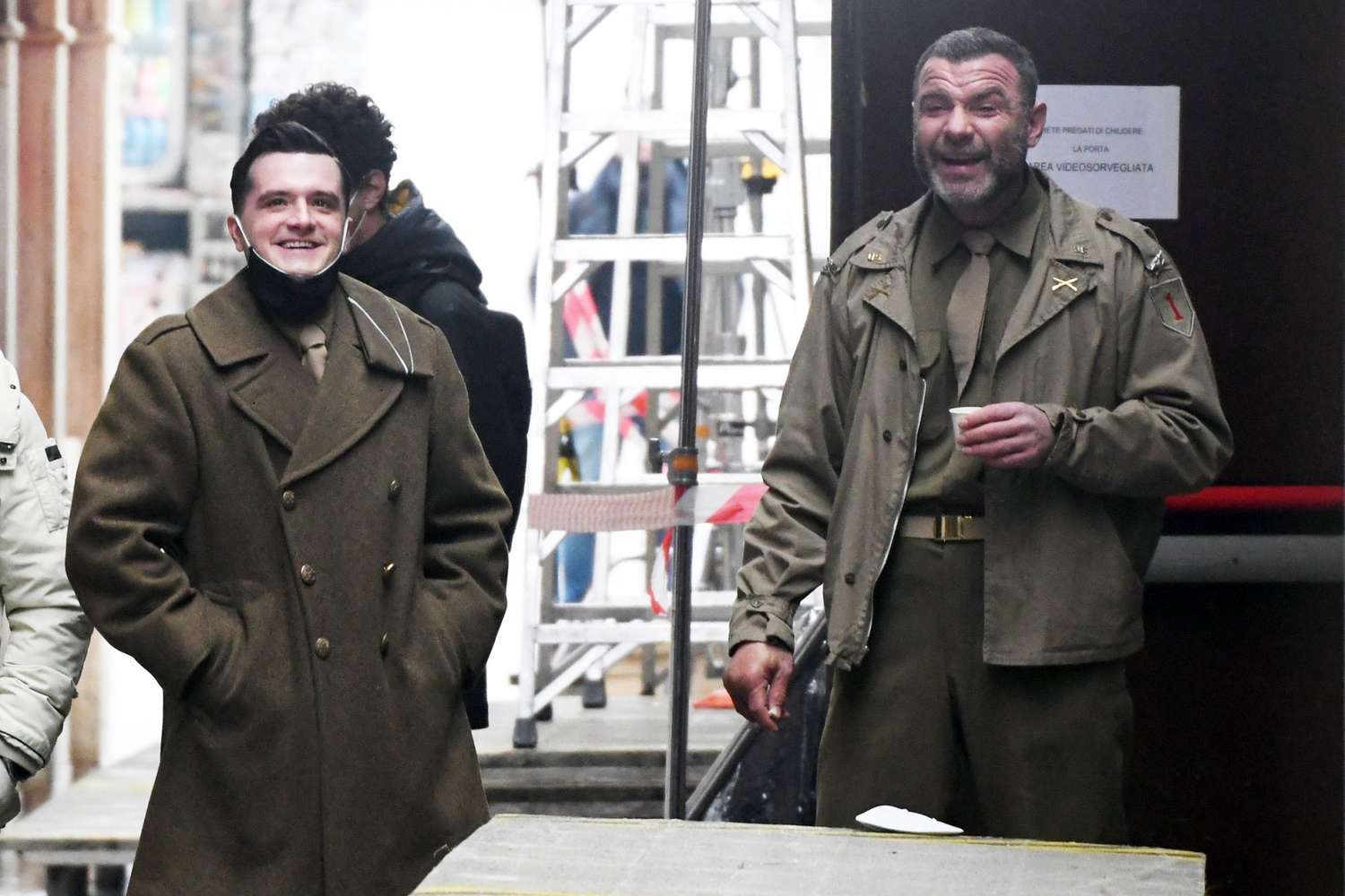 Liev Schreiber and co-star Josh Hutcherson enjoy a cigarette break while filming 'Across the River and Into The Trees' in Venice