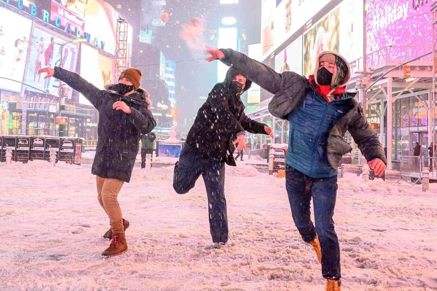 People throw snow balls during a snow storm in Times Square on December 16, 2020 in New York City