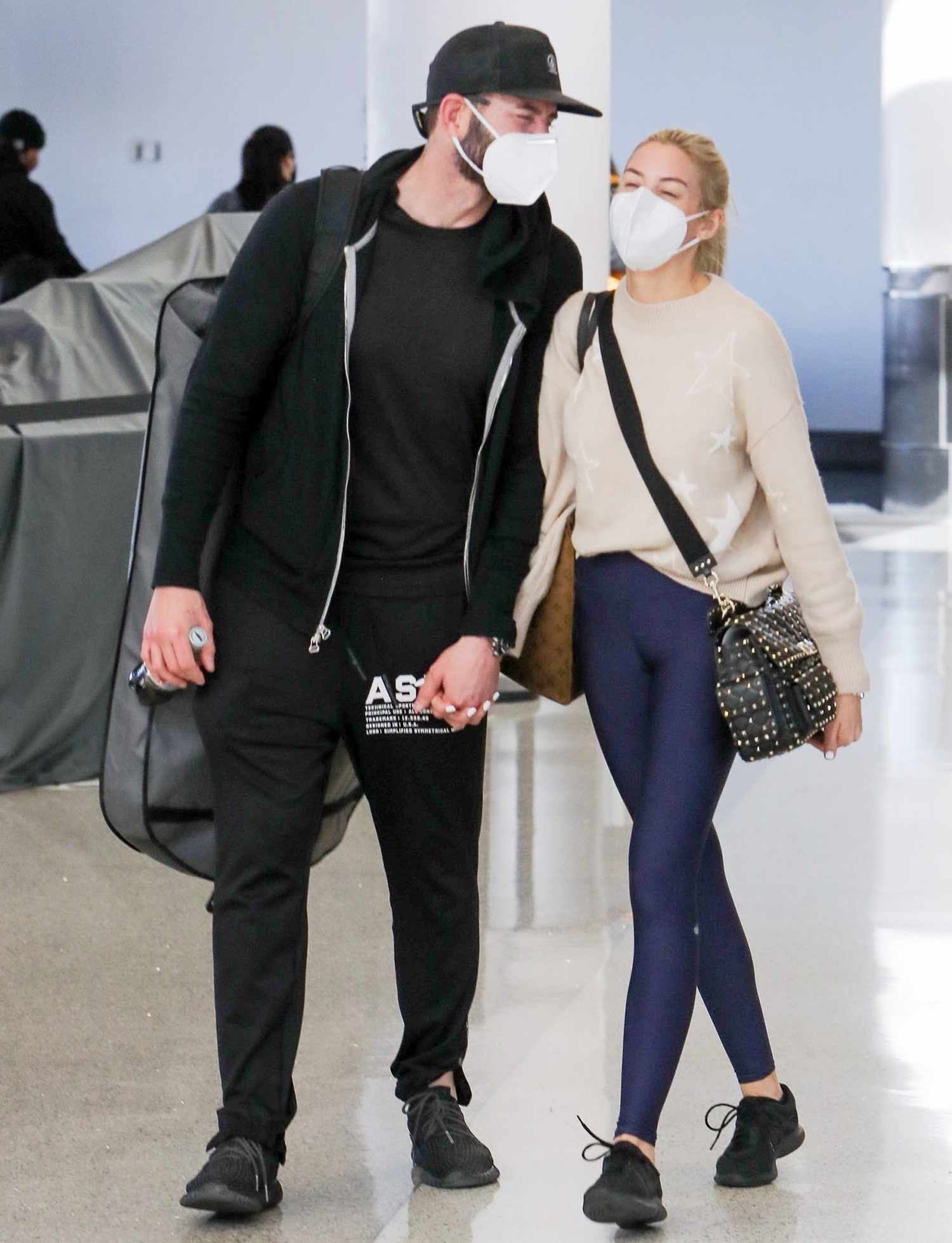 Tarek El Moussa and fianc&eacute; Heather Rae Young arrive at LAX