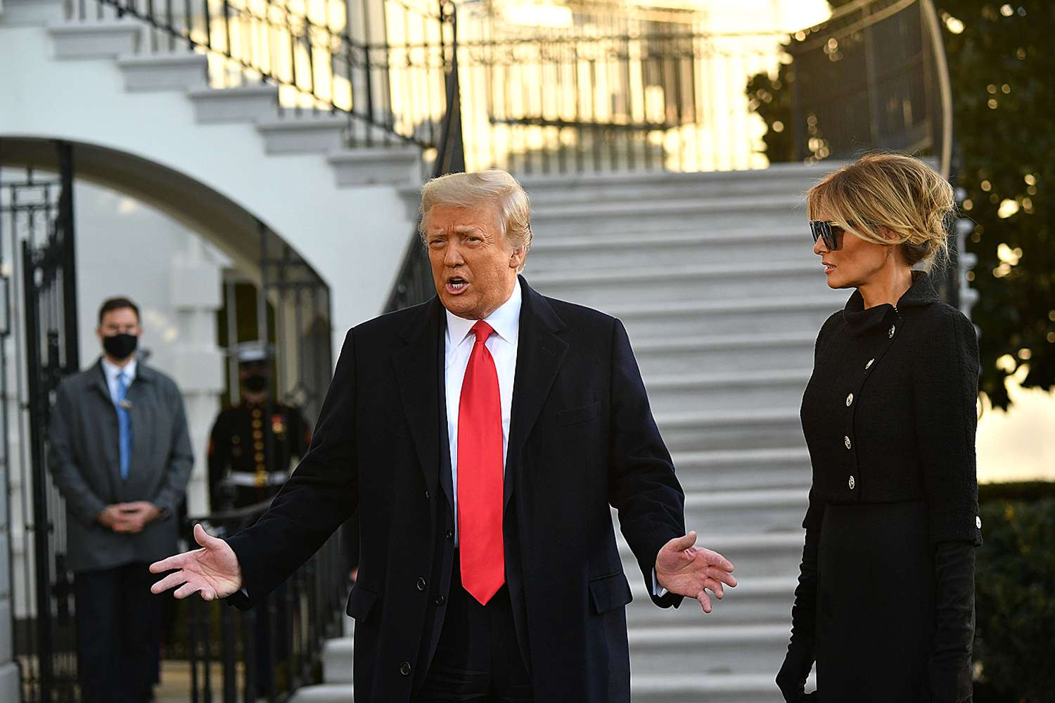 Outgoing US President Donald Trump and First Lady Melania Trump speak to the media depart the White House