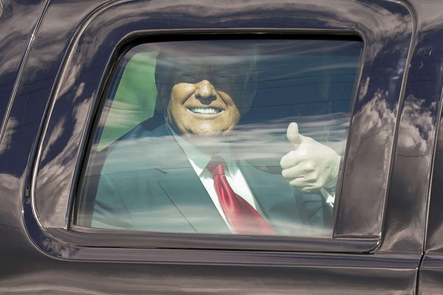 President Donald Trump gestures to supporters en route to his Mar-a-Lago Florida Resort, in West Palm Beach, Fla Biden Inauguration, West Palm Beach, United States - 20 Jan 2021