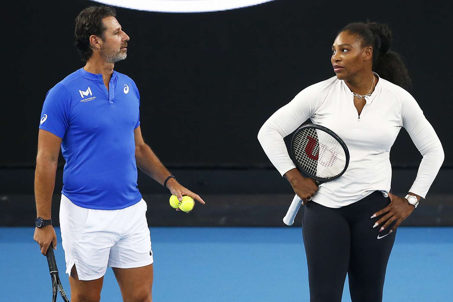 Serena Williams of United States speaks with coach Patrick Mouratoglou