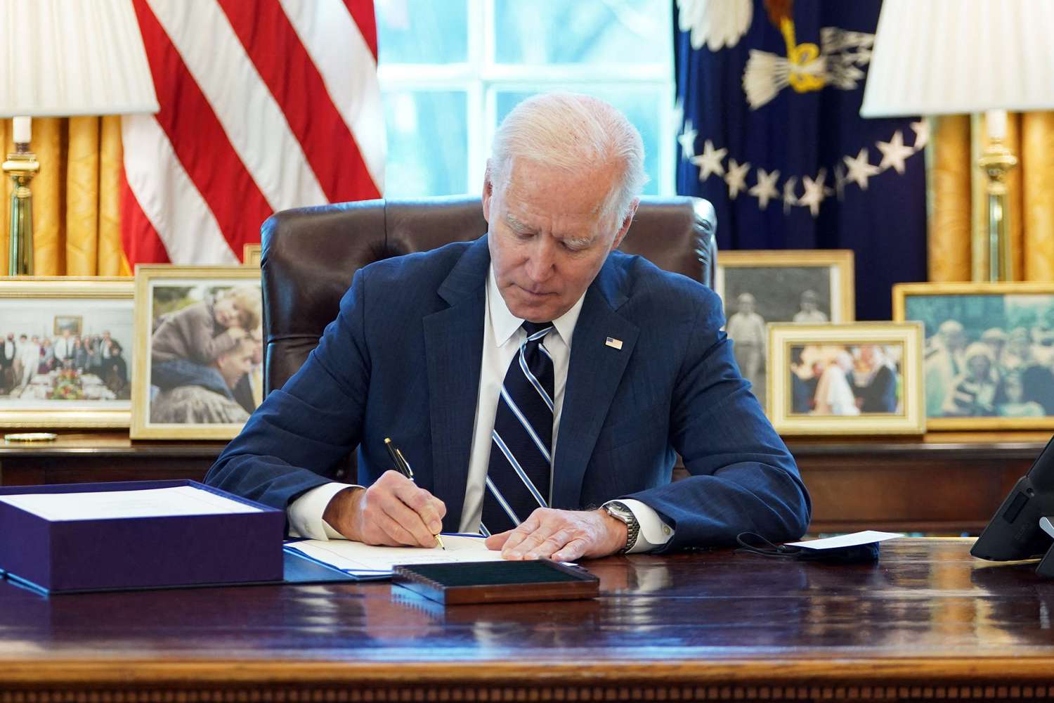 Joe Biden signs the American Rescue Plan on March 11, 2021