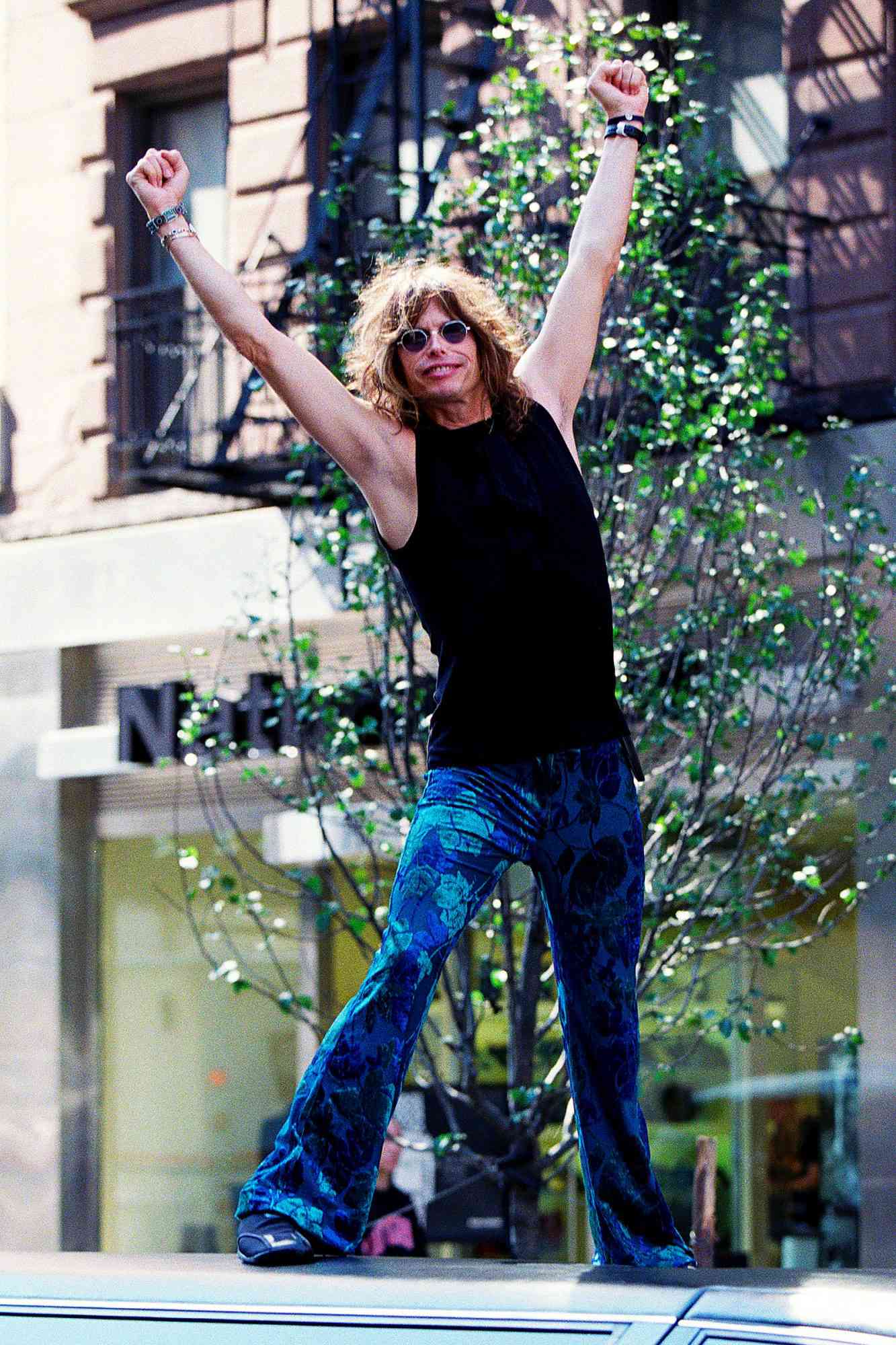 Steven Tyler, lead singer of Aerosmith, rock band, stood on top of his limousine in midtown Manhattan on September 20, 2000 in NYC