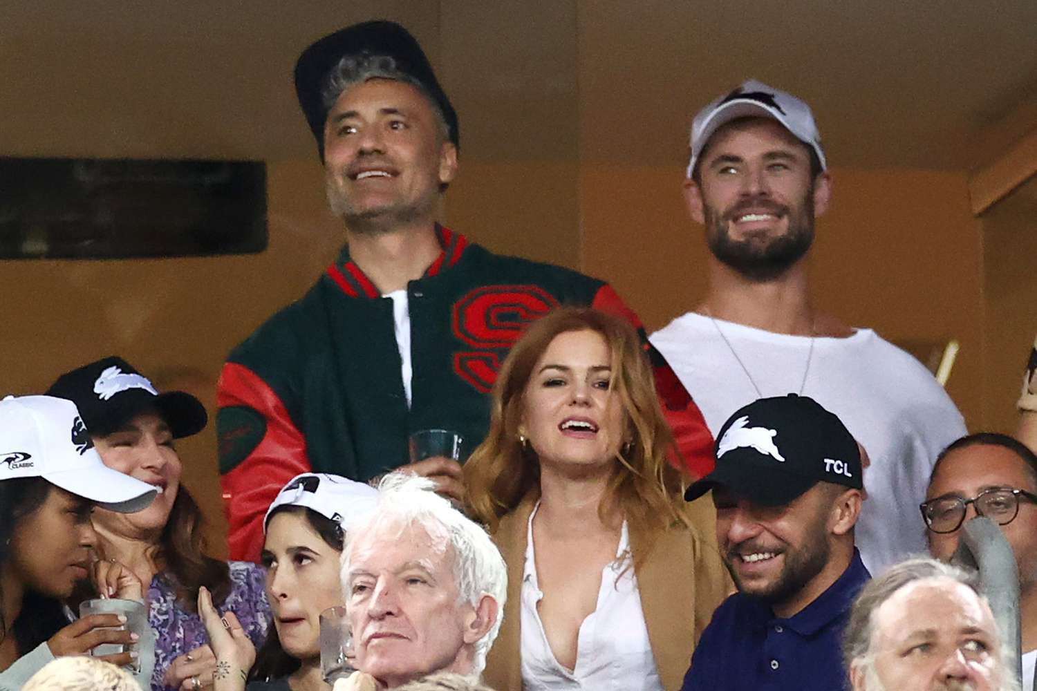 Taika Waititi, Chris Hemsworth, Elsa Pataky, Isla Fisher and Russell Crowe watch the round three NRL match between the South Sydney Rabbitohs and the Sydney Roosters at Stadium Australia on March 26, 2021, in Sydney, Australia