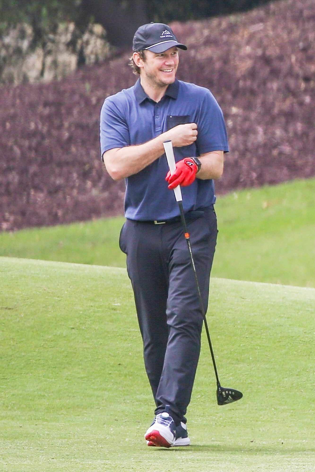 Chris Pratt works on his golf swing at a range session in Los Angeles