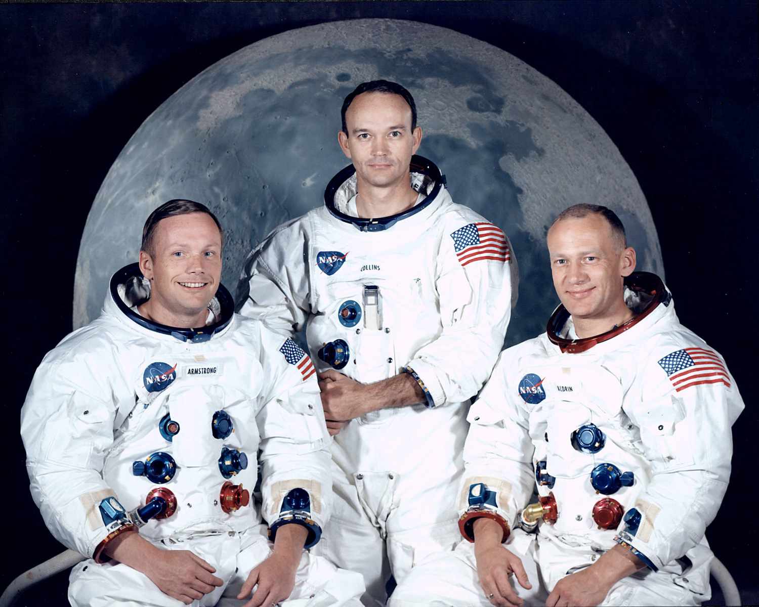 Group portrait of Apollo 11 lunar landing mission astronauts (L-R) Neil Armstrong, Michael Collins and Edwin Aldrin Jr. in spacesuits, at Manned Spacecraft Center.