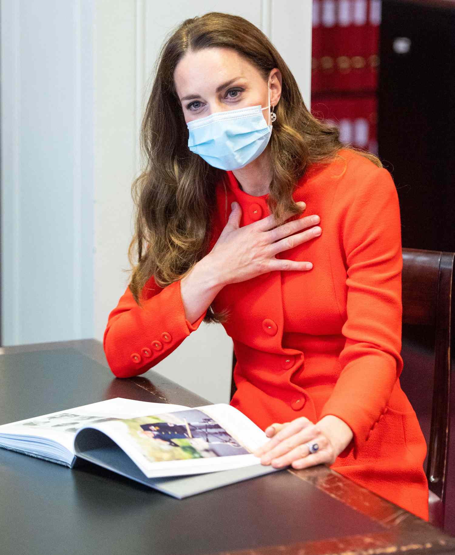 The Duchess of Cambridge talks to 'Hold Still' entrants during a visit to the archive in the National Portrait Gallery